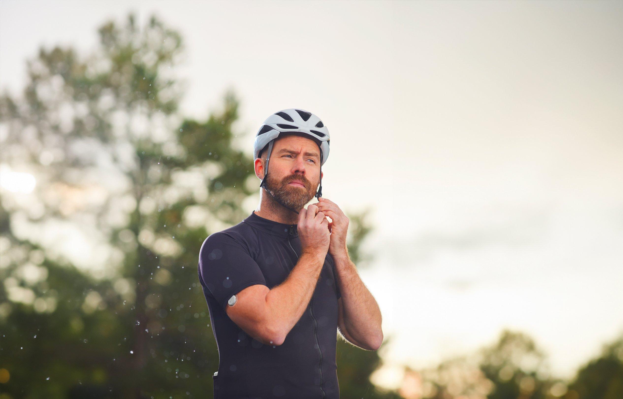 Femme avec le capteur Dexcom ONE+ sur le bras, vérifiant le récepteur Dexcom ONE+.